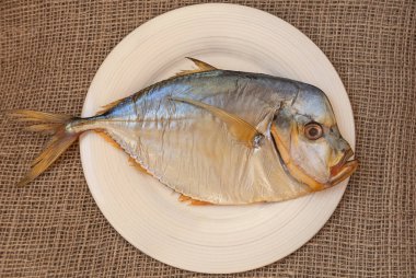 Smoked fish selene vomer on a porcelain plate. Fish and seafood clipart