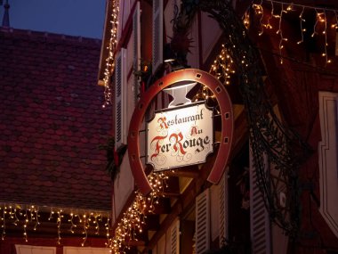 Colmar, Fransa - 26 Aralık 2024: Fransa 'nın Colmar kentinde Noel süslemeleri ile geleneksel restoran tabelası.