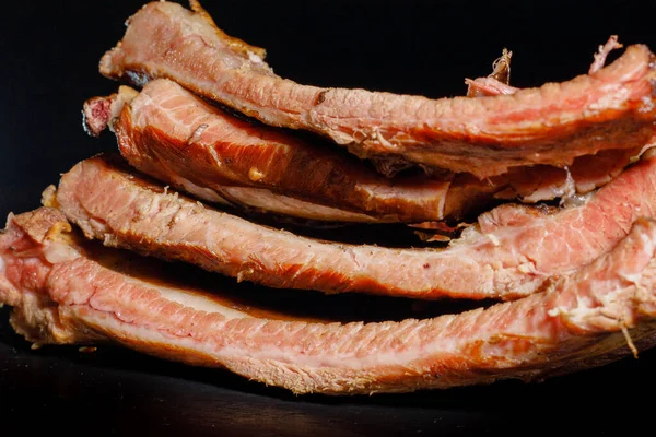 stock image Smoked cooked ribs on a black background.