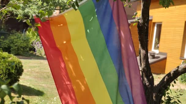 Lgbt Flag Placed Garden Which Sunlight Shines Shadows Tree Leaves — Stock Video