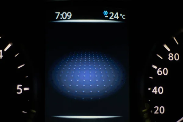 Car dashboard lights showing speed and temperature. Car instrument panel with speedometer and digital temperature.