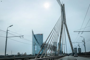 Riga road with car traffic in the spring period on the Vansu bridge. clipart