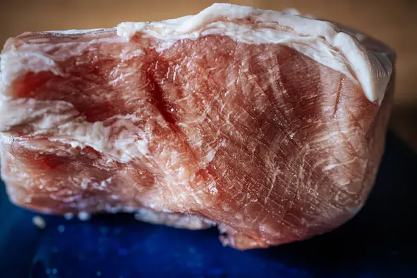 Frozen pork chop on a glass dish, plate.