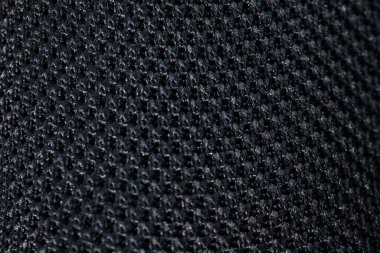 Koyu renkli, sıkı örülmüş, detaylı doku ve deseni gösteren aşırı yakın plan bir görüntü. İnce görsel ilgi ile tekstil veya arkaplan kullanımı için ideal.
