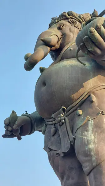 stock image The Ganesha statue holding a banana, symbolizing nourishment and sustenance, Thailand.