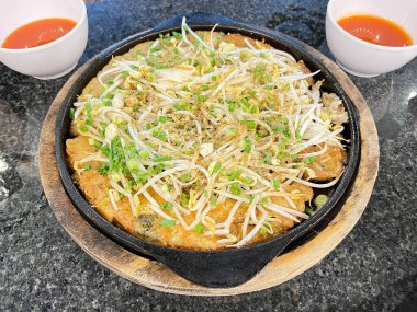 Sıcak tavada servis edilen çıtır istiridye omleti.