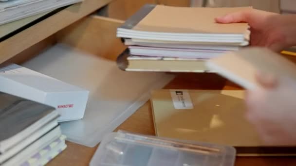 Process Moving Out Person Thoughtfully Packs Cherished Books Sturdy Blue — Stock Video
