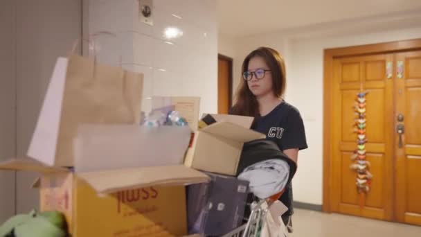 Sorgsen Ung Asiatisk Person Knuffar Fullpackad Vagn Navigerar Genom Livlig — Stockvideo