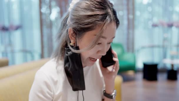 Young Asian Person Engages Captivating Conversation Phone Animated Expression Gestures — Stockvideo