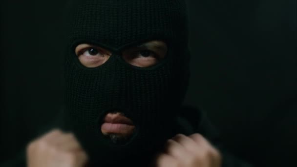 Latino Male Criminal Puts Ski Mask Hood Nods Head Looking — Stock Video