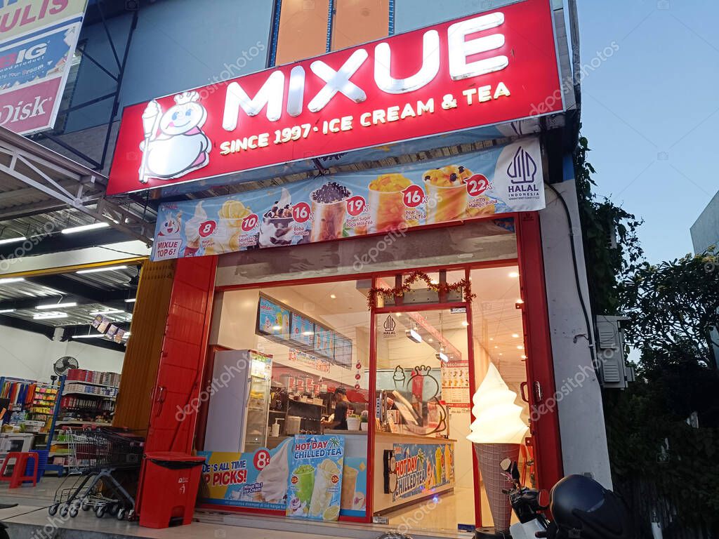 Bali, Indonesia - April 26, 2025: Mixue Ice Cream and Tea, a popular ice cream and tea restaurant, featuring its iconic red signboard with the snowman logo. Located in Tabanan, Bali in April 2025.