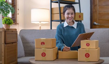 Küçük işletmeler kuran KOBİ 'li kadın girişimciler fatura kutusuna adresi yazın ve kutuları paketlemek, müşterilere satmak, iş fikirlerini çevrimiçi olarak satmak için online siparişleri işaretleyin...