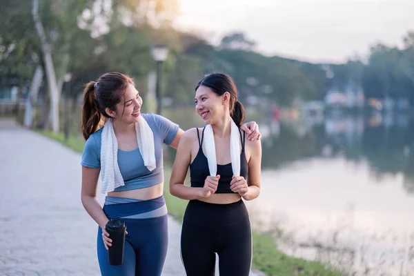 Beautiful view of two female joggers doing outdoor activities in a public park..