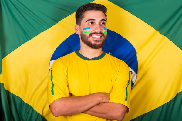 Caucasian, brazilian, latin american man cheering for brazil, world cup 2022, Vibrating and cheering with brazil flag background.