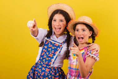 Festa Junina 'nın tipik kıyafetlerini giyiyorlar. Ufuk çizgisine bak, şuraya bak..