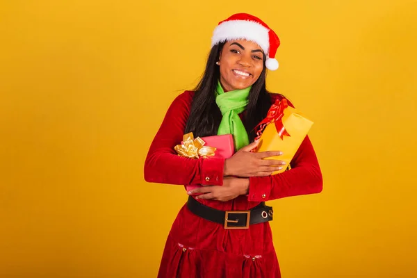漂亮的巴西黑人女人 身穿圣诞服装 圣诞老人 抱着两件礼物 — 图库照片