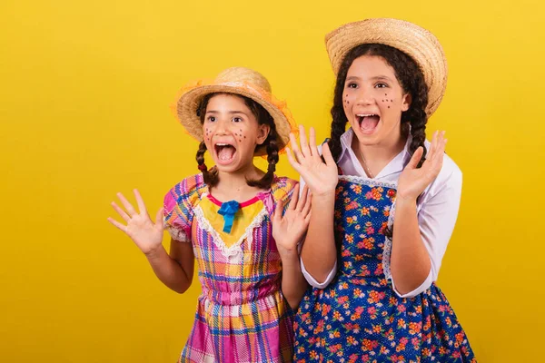 Stock image sisters and friends, wearing typical clothes of the Festa Junina. surprises, wow, incredible, unbelievable.