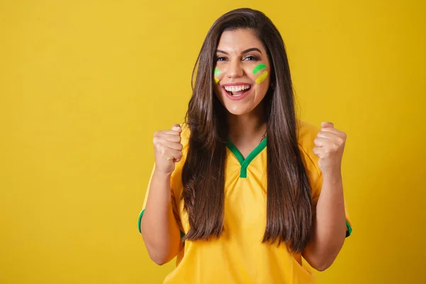 Woman supporter of Brazil, 2022 world cup, football championship, screaming goal, celebrating team victory and goal.