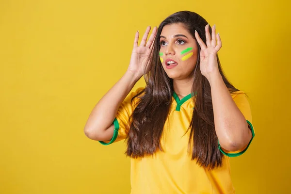 Stock image Woman supporter of Brazil, world cup 2022, football championship, anxious, attentive while watching the football match.