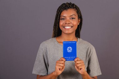 Genç Afrikalı bir kadın çalışma kartı ve sosyal güvenlik kartı tutuyor. Resmi belge, İnsan kaynakları, emek piyasası.