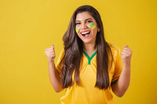 Woman supporter of Brazil, 2022 world cup, football championship, screaming goal, celebrating team victory and goal.