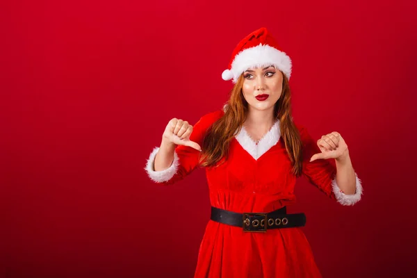 美しいブラジルの赤髪の女性 クリスマス服を着て サンタクロース 親指を下げて — ストック写真