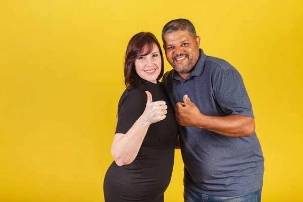 Brazilian couple, caucasian woman and black man, thumb up, like, positive. we love.