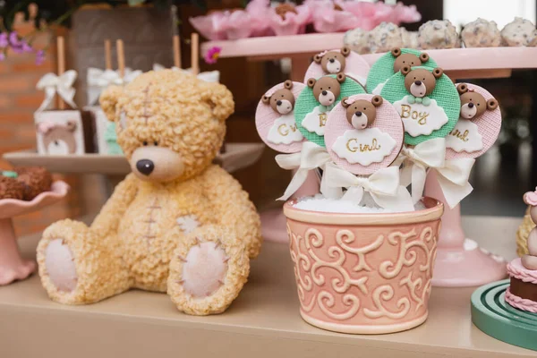 teddy bear decoration for baby gender reveal tea. with chocolate lollipops, typical Brazilian sweet.