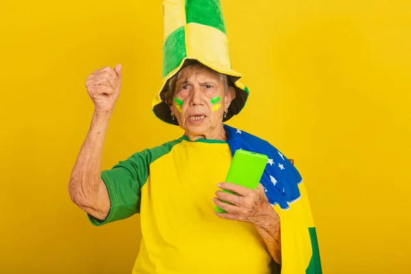 Starsza Kobieta Fanka Piłki Nożnej Brazylii Dopingująca Flagę Trzymanie Telefonu — Zdjęcie stockowe