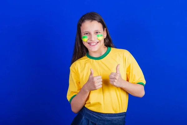 ブラジルのサッカーファンの少女です 親指を立てポジティブに — ストック写真