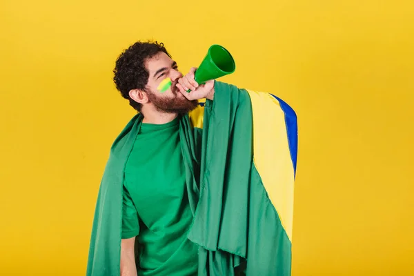 ブラジル出身の男ブラジル人髭サッカーファンボイスアンプでプロモーションを叫んでる 広告宣伝のための写真 — ストック写真
