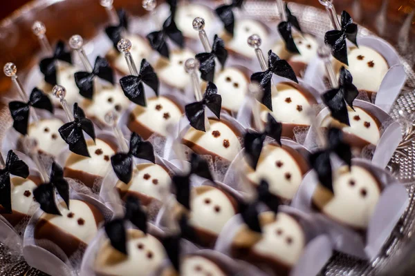 Delicious candy for weddings, sweets based on white and black chocolate.