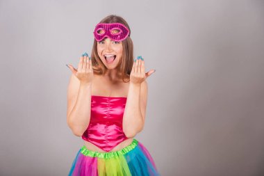 Pembe karnaval kıyafetleri giymiş Brezilyalı sarışın kadın. Maskeli, gel, ellerinle davet et..