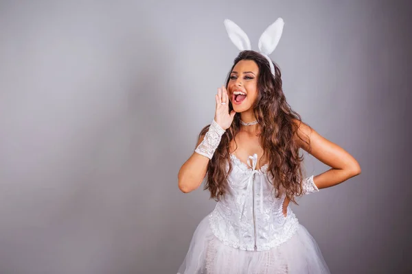 Brazilian woman, with bunny clothes. shouting promotion. advertising discount.