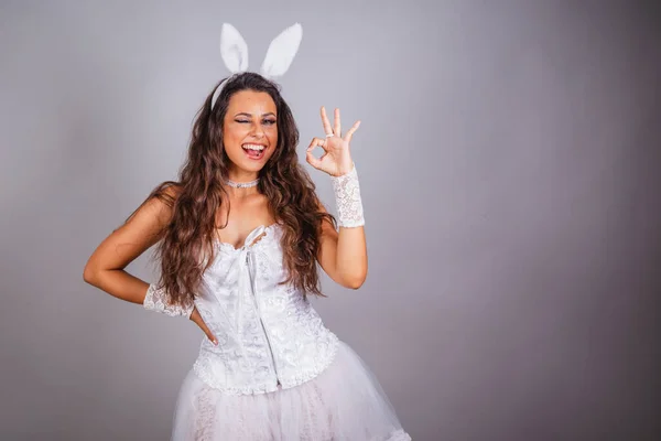 Brazilian woman, with bunny clothes. fingers ok sign.