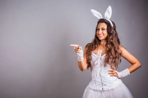 穿着兔子衣服的巴西女人在侧面展示广告 广告或产品 — 图库照片