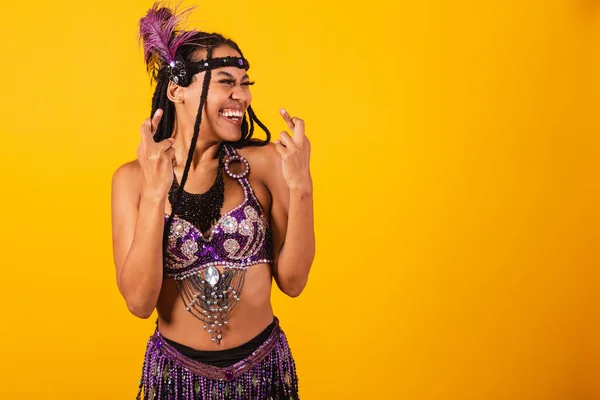 stock image beautiful black brazilian woman, in purple carnival clothes, cheering hard, wishing.