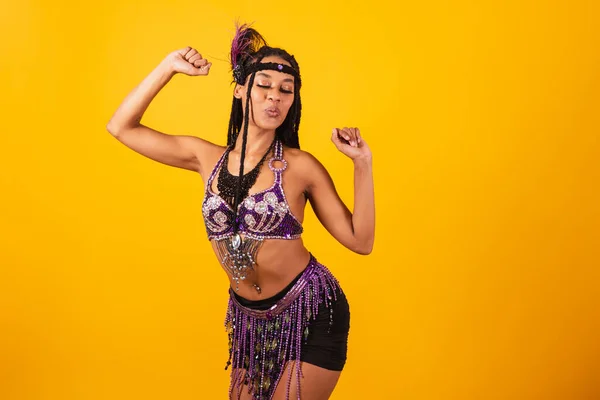 stock image beautiful black Brazilian woman, in purple carnival clothes, dancing.