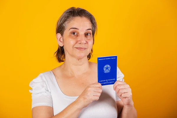 stock image adult Brazilian woman, holding work and social security card, Brazilian document for formal work.