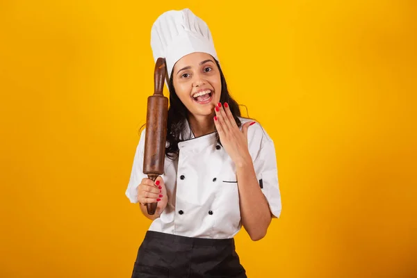 stock image Brazilian woman, head chef, cook, holding wooden rolling pin.