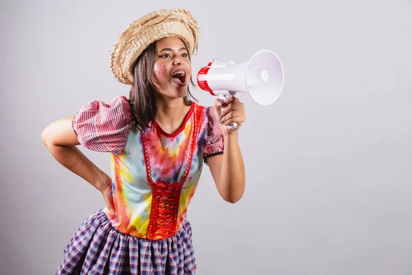 Stock image Brazilian woman wearing country clothes, So Joo party, Junina party. with megaphone, promotion, advertising 