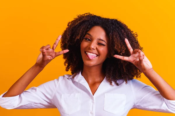 afro woman making V sign with hands. Happy afro girl with good vibe making peace and love with hands
