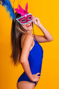 Karnaval gecesi için giyinmiş güzel bir kadın. Maskeyle karnavalın tadını çıkarmaya hazır gülümseyen kadın.