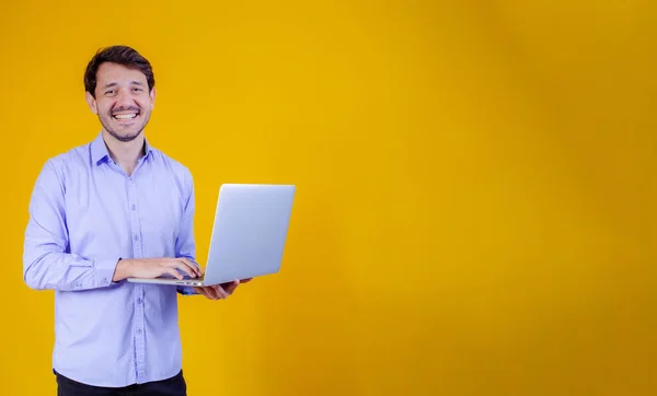 Knappe Man Werken Met Zijn Laptop Gele Achtergrond — Stockfoto