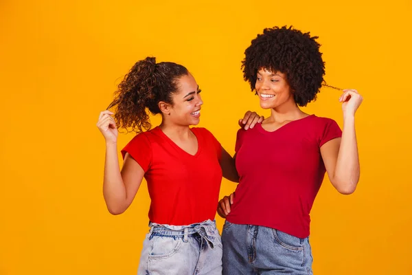 stock image Young beautiful and happy afro female friends smiling to the camera.