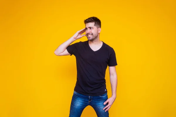 handsome man forgotten and confused on yellow background