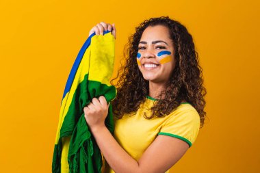 En sevdiği Brezilya takımı için tezahürat yapan Afro kız, sarı arka planda ulusal bayrak taşıyor..