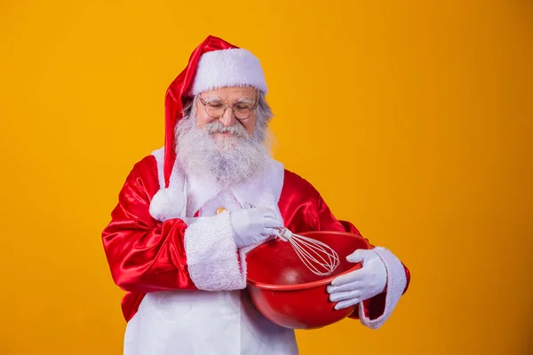 Santa Claus Bowl Beating Cake Yellow Background — Stock Photo, Image