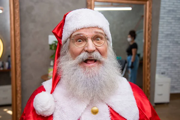 stock image The real Santa Claus, wearing glasses, gloves and a hat looking straight into the camera. Close up. The real Santa Claus looking at camera