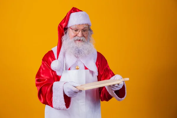 Santa Claus Dressed Apron Holding Empty Meat Board Yellow Background — Stock Photo, Image